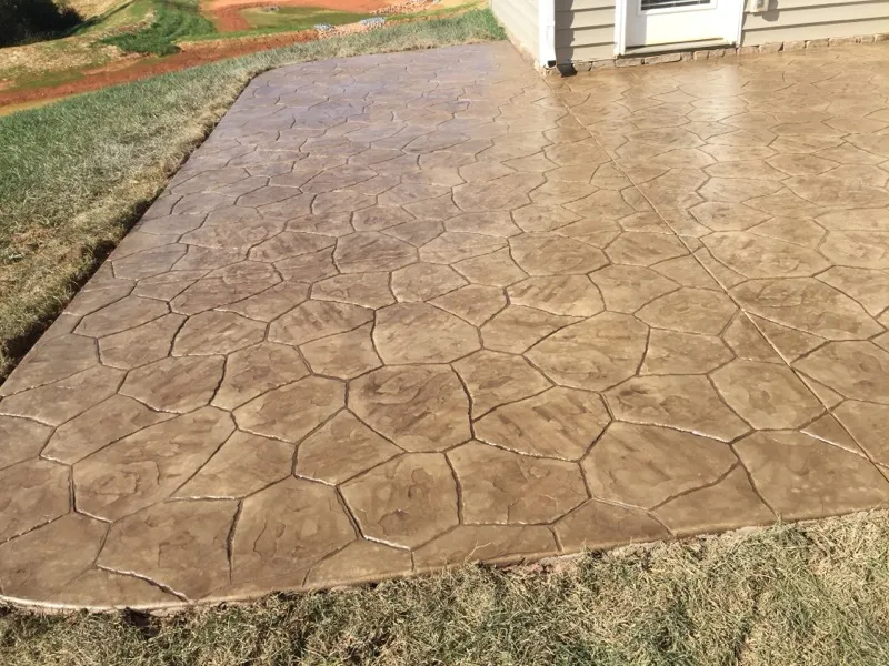 Brown stamped concrete patio installed in Charlotte, NC by Stamped Concrete Artisans
