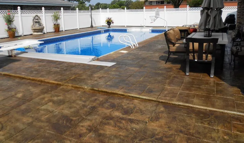 Brown stamped concrete pool deck installed in Charlotte, NC by Stamped Concrete Artisans